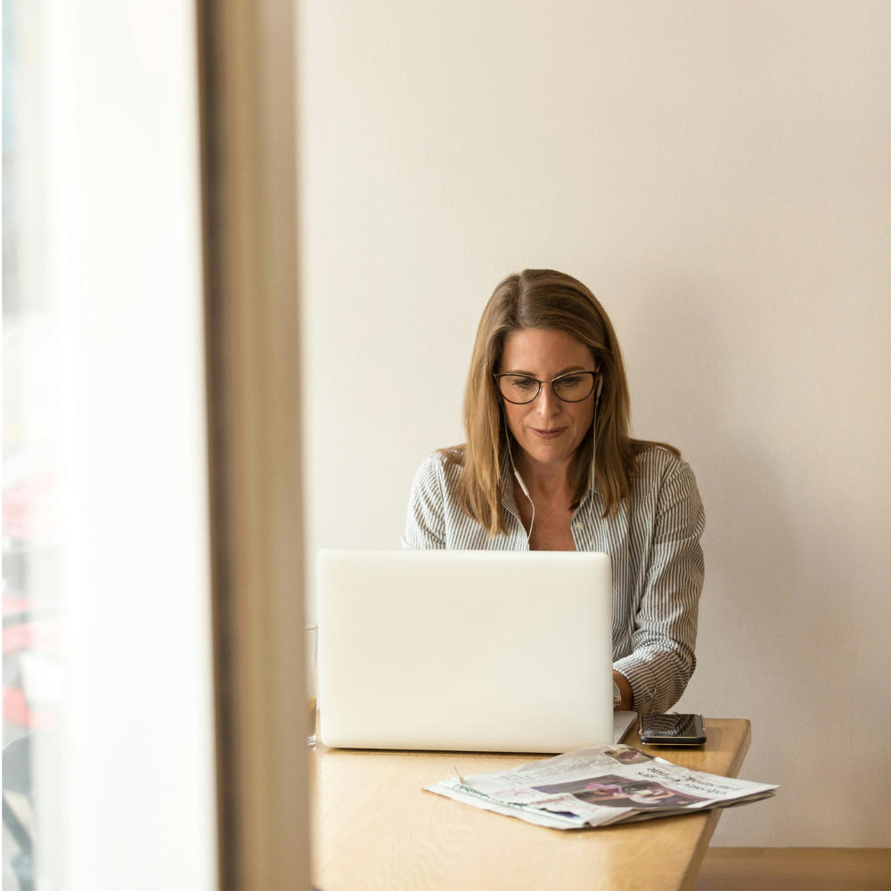Business professional on a client call managing bookkeeping and financial records